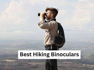 A man watching scenery through binoculars in hiking
